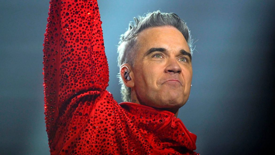 Was ist mit Robbie Williams passiert? Der Sänger erklärt den weißen Gegenstand im Live-TV beim WM-Finale 2026: Kokain-Gerücht oder Pfefferminzpastille.